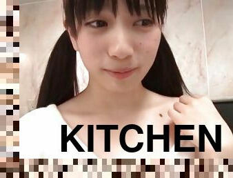 Pigtailed cutie cleans kitchen in a soft sweater