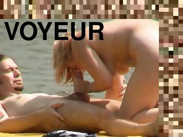 Voyeur watches couple fucking on the beach