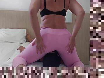 Face sitting in pink leggings