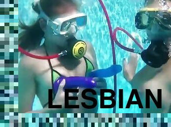 Two hot lesbians playing with dildos in the pool
