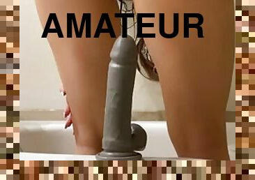 Horny teen rides a dildo in the bath