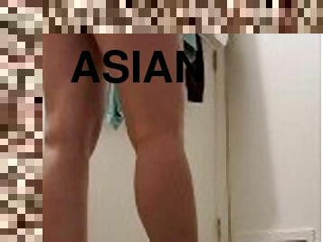 Asian changing in her room