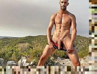 Naked latin man edging on the mountains. Risky public masturbation