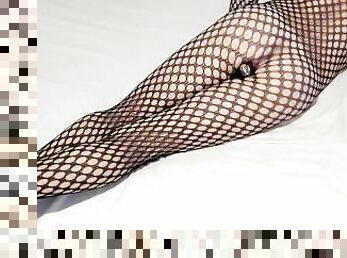 I'm a slut in a fishnet suit and a dildo in my ass