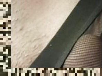 man touches his cock in his fishnet underwear