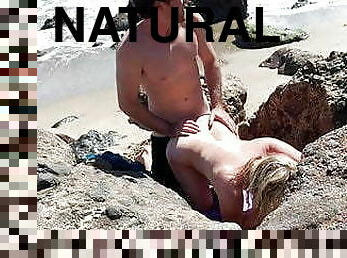 Voluptuous blonde sunbathing nude on beach fucks passerby