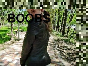 Schoolgirl with big eyes walks in the park after school in a leather jacket