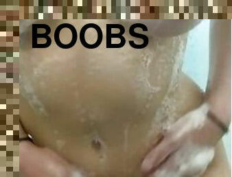Sexy teen showers and plays with soapy tits