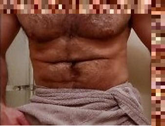 MUSCLE BEAR FLEXING IN TOWEL BEFORE SHOWER