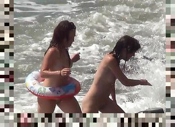 Sensual models are walking naked in the sea
