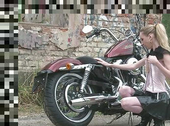 Cute teen is amazed by a big bike