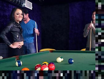 Dudes play pool when brunette in black leather joins them