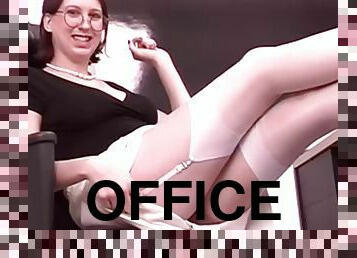 Sexy redhead office worker stretches her pussy with a dildo at her desk