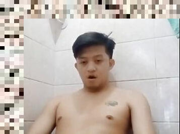 Young Asian guy in the bathroom pissing and jerking off