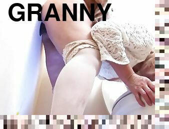 Horny granny sucks and fucks a black cock through a public hole