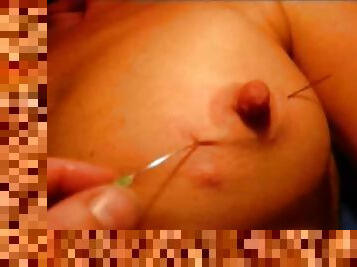 Long needle through her milf nipple