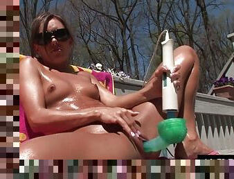 Petite brunette oiled up to masturbate in the sun with Hitachi