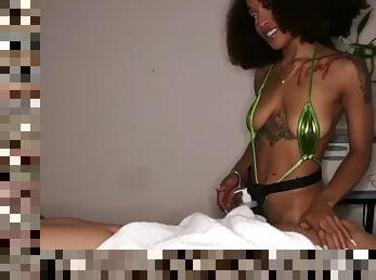 Tattooed ebony masseuse in a rare bikini jerks off a cock