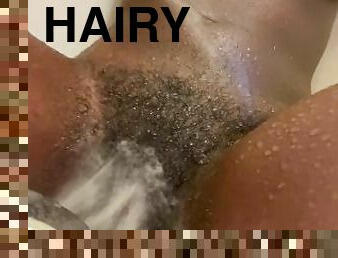 The shower head makes my hairy petite pussy feel so good
