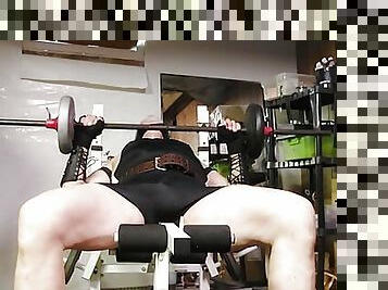 Leather guy lifting weights 