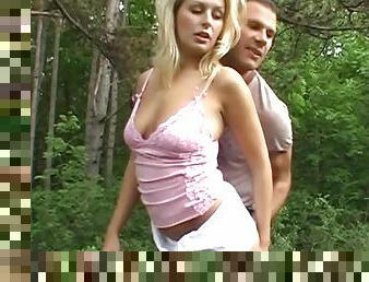 Slutty blonde gets banged from behind in the forest