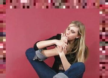 Pretty blonde licking her feet sensualy