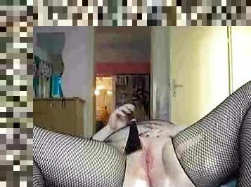 Fatty in fishnet lingerie masturbates pink pussy