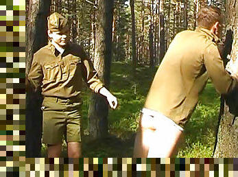 Sexy soldiers are spanking each other in the forest