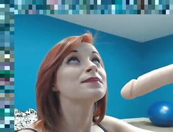 Redheaded camgirl blows a dildo erotically