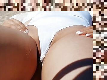Husband films hot wife on the beach. She opens her white swimsuit and shows pussy.
