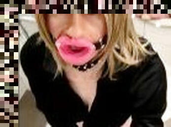 Sissy in chastity is riding a dildo and getting an intense sissygasm while wearing a lip gag