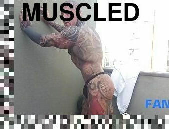 The legend of muscles and ink: Tattooed giant Rob Diesel, shows his power on the balcony