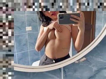 Showing off my sweet tits in the college bathroom.